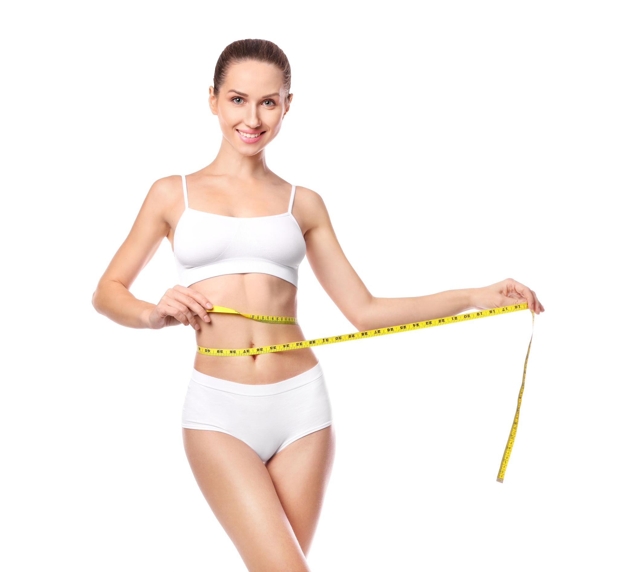 Woman measuring her waist with a yellow tape measure on a white background