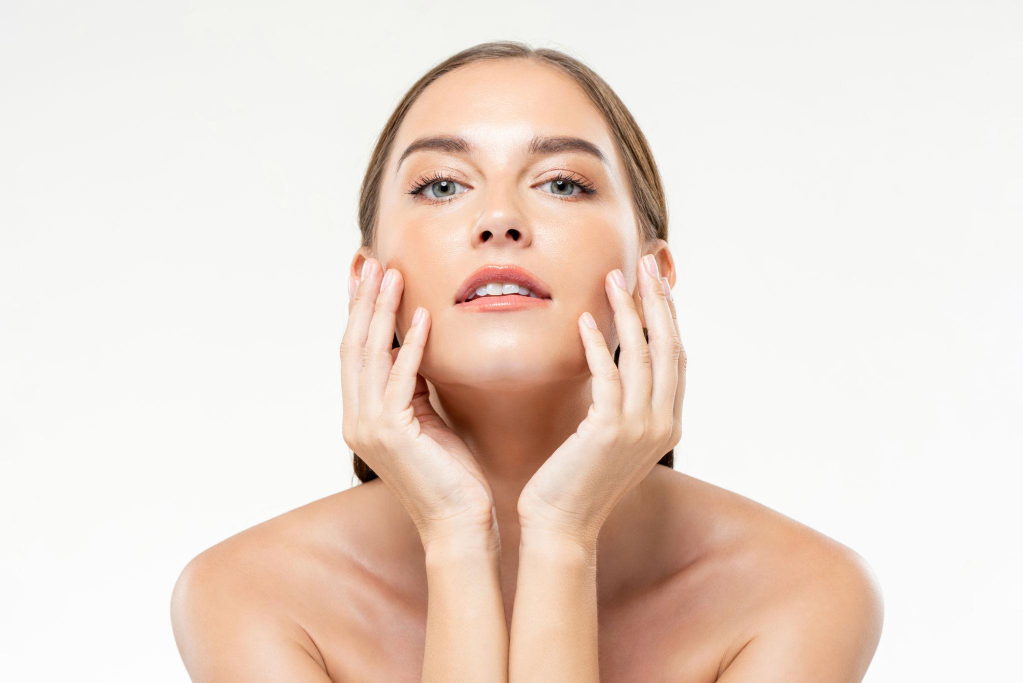 Woman touching her face with a white background